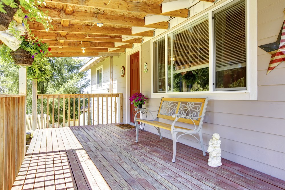 A front porch deck with a roof above